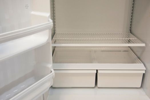 Bottom shelves and crisper in an empty refrigerator