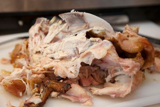  Carcass of a cooked chicken on the counter with meat and bones