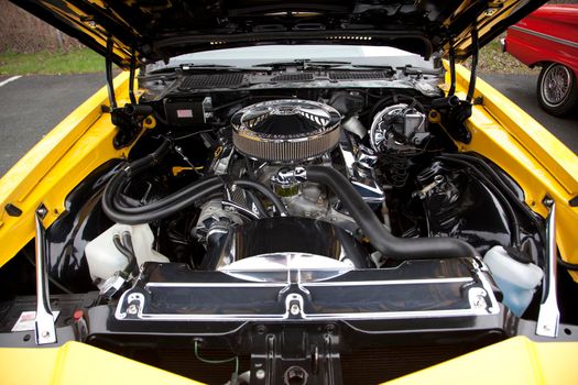  May 11, 2019- Eastern Passage, Nova Scotia- under the bonnet of a beautiful antique yellow 1977 Chevy Z28 Camaro at a car show