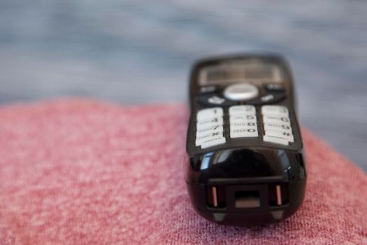  A black cordless phone sits waiting to be picked up or dialed 