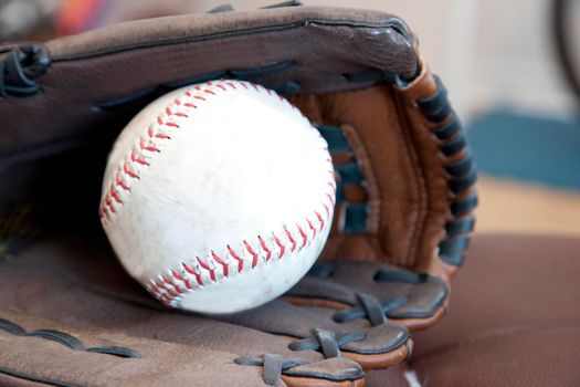  A softball and leather glove ready to play ball 