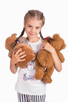 Little girl holding a teddy bear. Isolated on white background. Girl hugging two teddybears. Happy child.