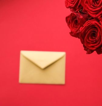 Holiday gift, flowers flatlay and happy relationship concept - Love letter and flower delivery service on Valentines Day, luxury bouquet of red roses and card envelopes on red background