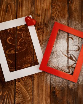 photo frames with heart and coffee silhouette from coffee and powdered sugar on wooden background