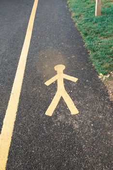 pedestrian path with a sign on the roadway