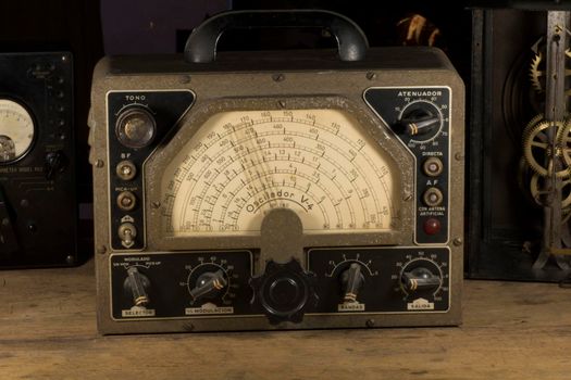 Old electronic gadgets on a wooden table, old technology.