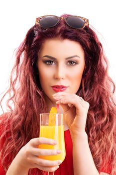 Close up of a beautiful redhead young woman drinking from a cocktail or orange juice glass, isolated on white background. Summer time, cocktail, health concept.