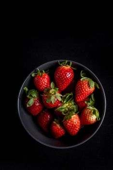 Strawberries in background black.