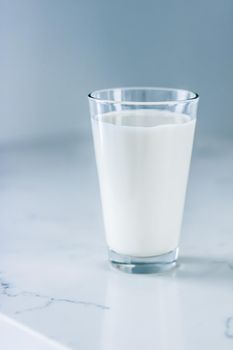 Dairy, healthy nutrition and breakfast concept - World Milk Day, full glass on marble table