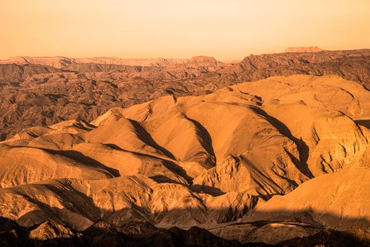 A view from the crater in the Ramon Crater. Arid desert view. White sands and a horizon of blue skies. Negev, Israel. High quality photo