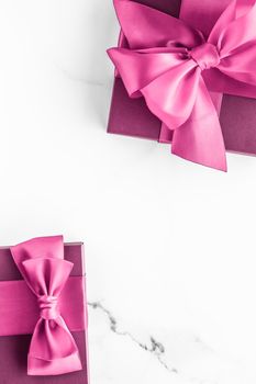 Birthday, wedding and girly branding concept - Pink gift box with silk bow on marble background, girl baby shower present and glamour fashion gift for luxury beauty brand, holiday flatlay art design