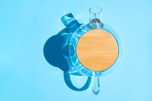 glass teapot with a hard shadow on a colored background. High quality photo