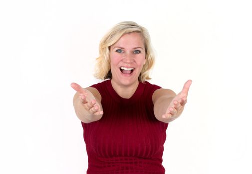  a blonde woman smiles with arms outstretched in a welcome, inviting expression