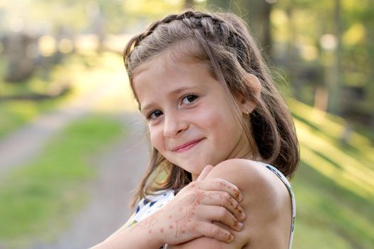 portrait of a smart looking young girl with a henna tattoo on her hand 
