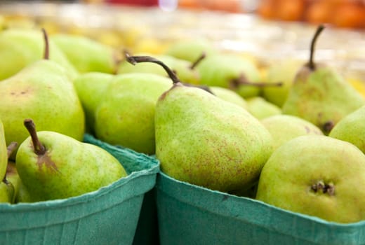 boxes of fresh green pear fruit at the market 
