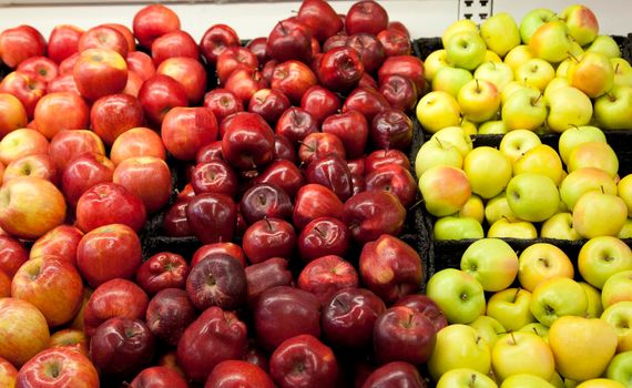 a variety of apple types and shapes at the supermarket
