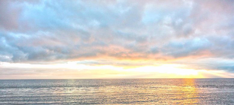  beautiful bright pink and yellow sky with the ocean in the morning