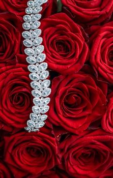 Gemstone jewellery, wedding fashion and luxe shopping concept - Luxury diamond bracelet and bouquet of red roses, jewelry love gift on Valentines Day and romantic holidays present