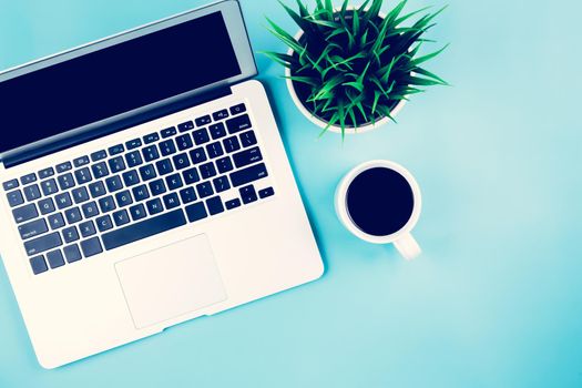 Flat lay of Laptop computer and plant and cup of coffee on desk in office, workplace and notebook and potted tree, workspace and copy space, top view, object with above, business concept.