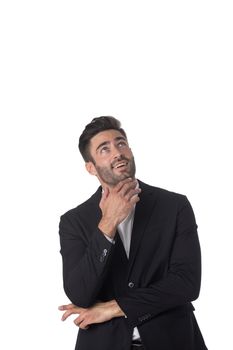 Portrait of young handsome business man in black suit looking up holding hand on chin studio isolated on white background