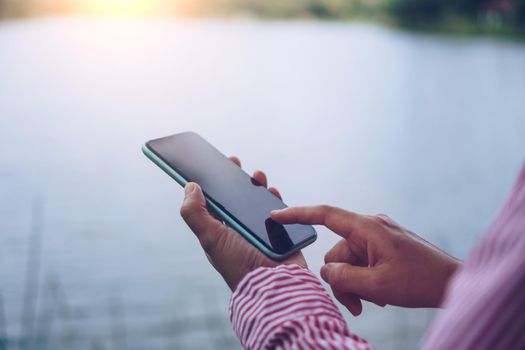 Woman hand using smartphone to do work business, social network, communication concept.