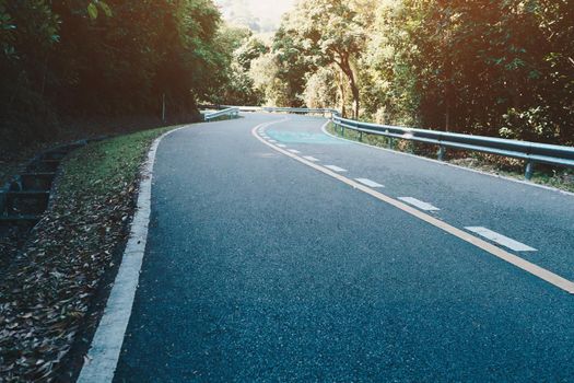 Road with bicycle lane in the country with nature surrounding background.