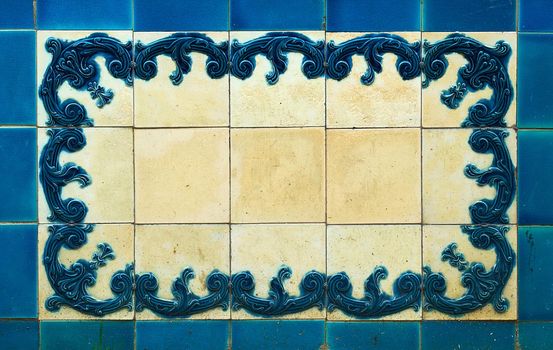 The elaborate design on the tiles is embossed and stained blue. The white areas are worn and stained yellow.