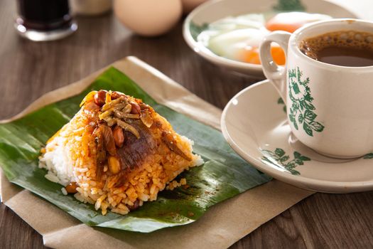 Common oriental breakfast set in Malaysia consisting of coffee, nasi lemak, toast bread and half-boiled egg