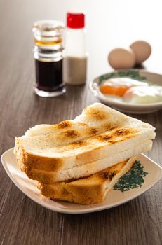 Common oriental breakfast set in Malaysia consisting of coffee, nasi lemak, toast bread and half-boiled egg