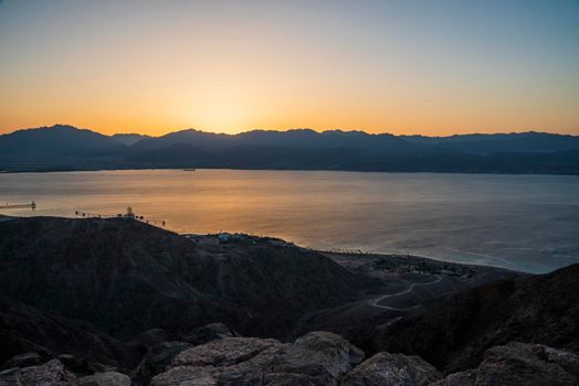 Dawn rises beyond the Aqaba mountains. Sunrise over the Red Sea. A look at Mount Shlomo, Eilat, Israel. High quality photo