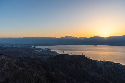 Dawn rises beyond the Aqaba mountains. Sunrise over the Red Sea. A look at Mount Shlomo, Eilat, Israel. High quality photo