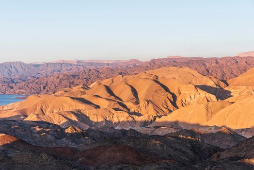 Arid desert mountains against the backdrop of the Red Sea. Shlomo mountain, Eilat Israel. Morning Daylight . High quality photo