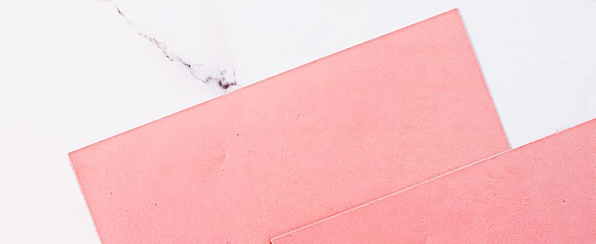 Pink A4 papers on white marble background as office stationery flatlay, luxury branding flat lay and brand identity design for mockups