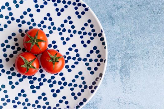 Cherry tomatoes on blue dotted plate