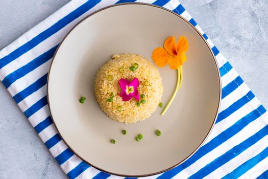 Quinoa plate presentation decorated with edible flowers