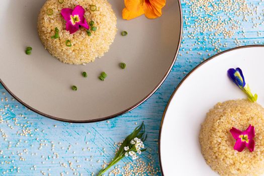 Quinoa plate presentation decorated with edible flowers