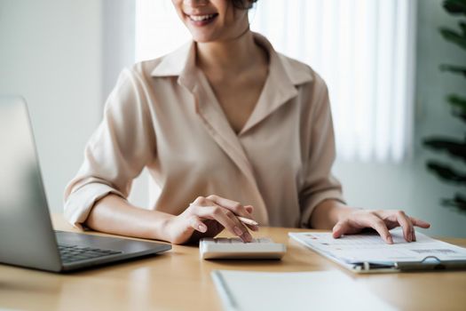 Closeup of Accountant female calculating tax report. Financial, business,analyze concept