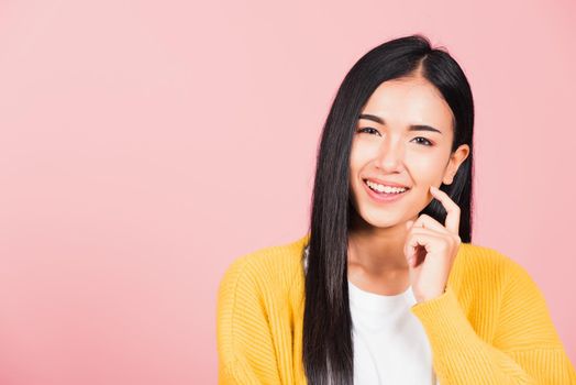 Portrait Asian beautiful young woman smiling standing chin handle relaxed thinking about something about the question studio shot isolated on pink background, Thai female idea think with copy space