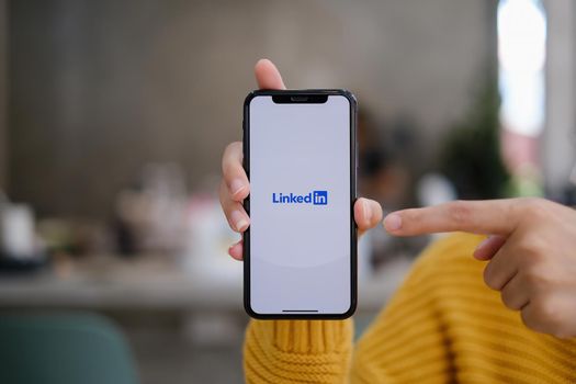 CHIANG MAI, THAILAND: MAY 03, 2021 : LinkedIn logo on phone screen. LinkedIn is a social network for search and establishment of business contacts. It is founded in 2002.