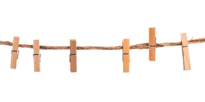 Wooden Clothespins with the rope on a white background
