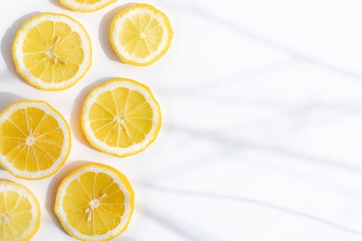 Sliced lemon on a white background . Lemon layout. Sliced fruit. Yellow color. White background. Light and shadow. Citrus. Healthy food. Copy space