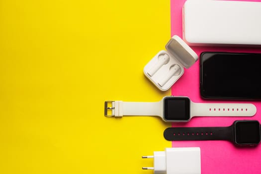 Layout of modern gadgets on a pink and yellow background . Online communication. Internet connection. Mobile communication. 5g. Black and white technology. Modern technologies. Copy space