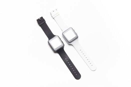 Electronic wrist watch on a white background . White and black wrist watches. Women's and men's watches. Isolated background. Article about modern watches. Article about choosing a watch. Copy space