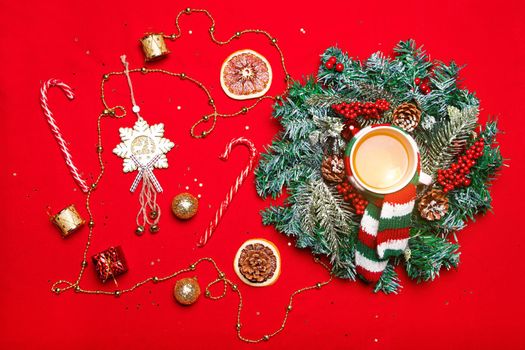 Christmas layout on a red background . New year's layout on a red background . Holiday. Holiday card. The view from the top. Christmas wreath. Fir-tree branches. Red background