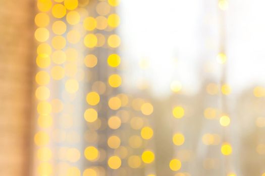 Yellow bokeh lights blur . new year's defocus. lights of the bokeh garland. Copy space to the side