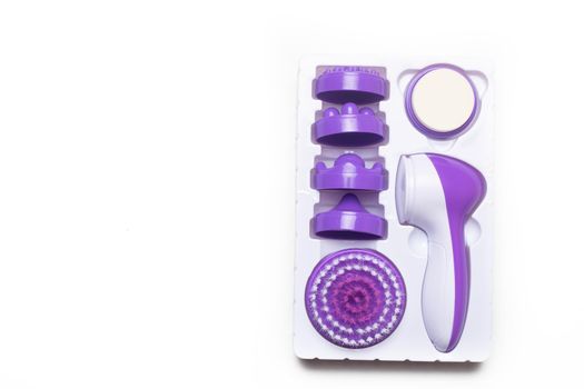 Electric isolate facial massager . Purple massager. Facial care. Cosmetology. Women's care . Article about the health of the face . Isolated object . Copy space