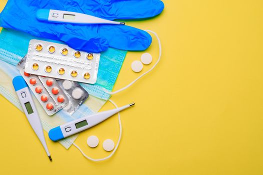 A pile of pills on a yellow background . Treatment and prevention. Article about the purpose of treatment. A cure for the disease. Pills in a blister. Lots of medicine. Yellow background. Copy space