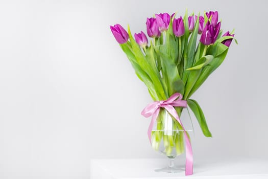 A bouquet of lilac tulips in a vase . Bouquet of tulips. Flowers in a vase. A greeting card. Delicate flowers. Valentine's day. March 8. Mother's Day. Copy space