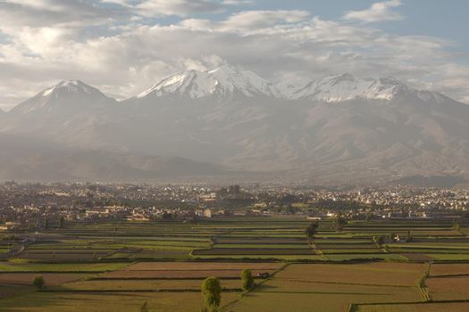 City of Arequipa, Peru with its iconic fields and volcano Chachani in the background