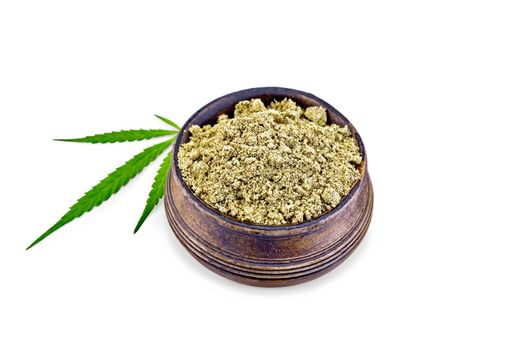 Hemp flour in a bowl, cannabis leaf isolated on white background